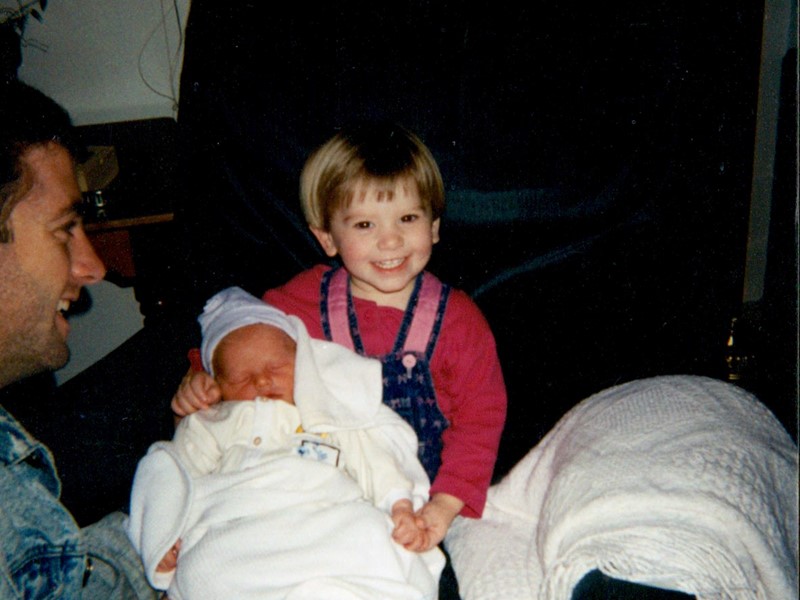 Bonnie, my oldest child, holding her brother Dallin